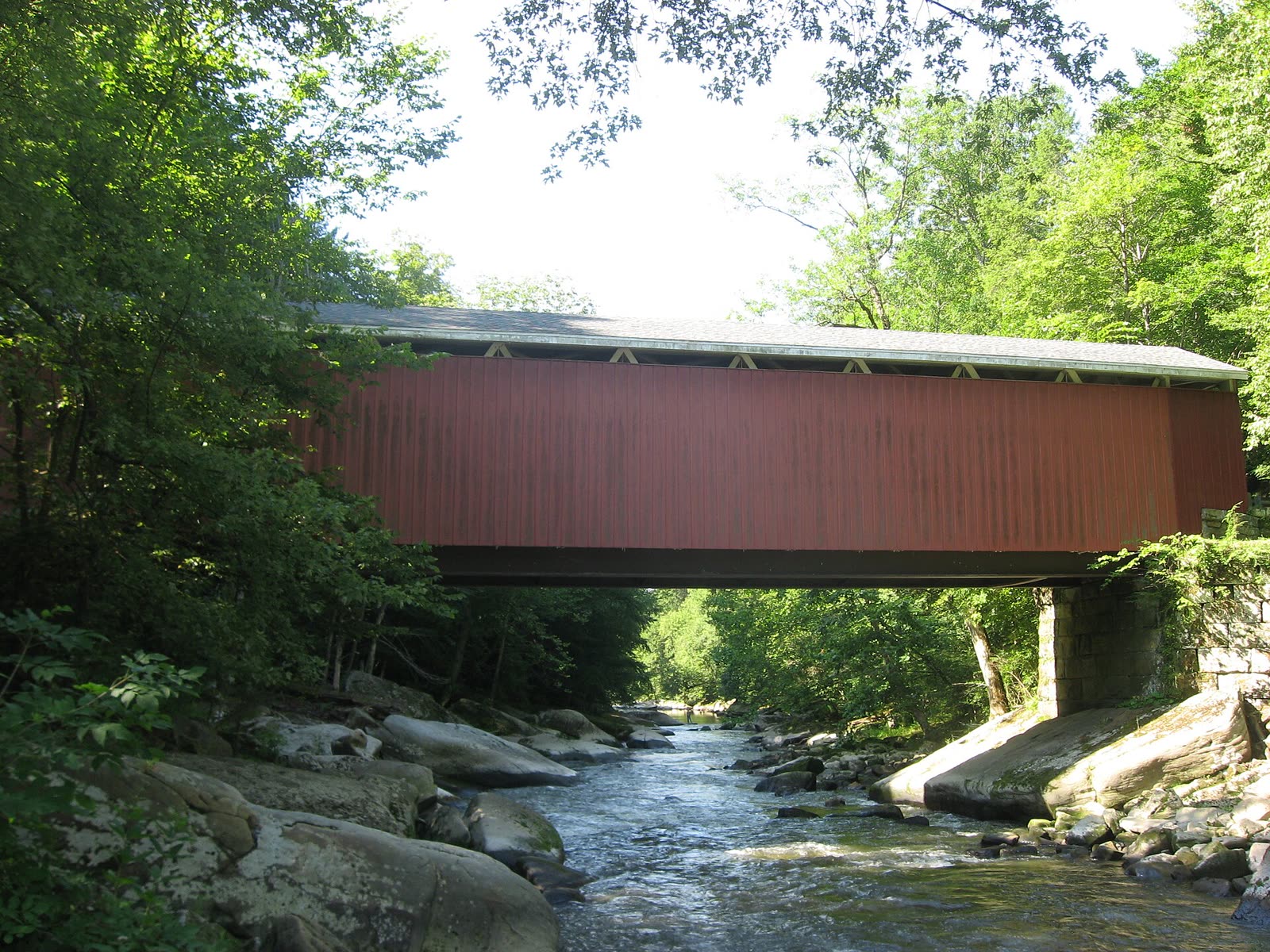 The covered bridge over Slippery Rock Creek in afternoon sunlight